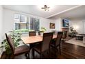 Bright dining area with hardwood floors, complemented by a window view and comfortable seating at 1825 S Pitkin Cir # 10, Aurora, CO 80017