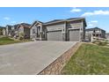 Attractive three-car garage home with stone accents and a long driveway at 5723 Berry Ridge Way, Castle Rock, CO 80104