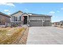 Charming home with a three-car garage, stone accents, and well-maintained lawn at 5723 Berry Ridge Way, Castle Rock, CO 80104