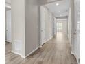 Hallway featuring wood floors, neutral paint, and white trim at 5723 Berry Ridge Way, Castle Rock, CO 80104