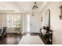Bright foyer with hardwood floors, tall ceilings, plantation shutters, and an elegant console table with decor at 14537 Honolulu Cir, Parker, CO 80134