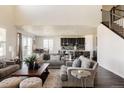 Open-concept living room flows into the kitchen, featuring hardwood floors and lots of natural light at 14537 Honolulu Cir, Parker, CO 80134