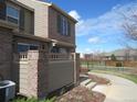 The outdoor patio area is partially enclosed and leads toward the sidewalk and green spaces at 559 Alton Way # E, Denver, CO 80230