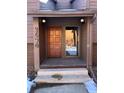 A townhouse front door with brick entryway, brown wood door, and sidelight with house number visible at 2630 Juniper Ave # 37-6, Boulder, CO 80304