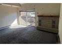 Vacant living room featuring fireplace and sliding glass doors that lead to outdoor deck space at 2630 Juniper Ave # 37-6, Boulder, CO 80304