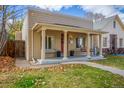 Cozy front porch with seating and classic columns, perfect for relaxing outdoors at 3929 Shoshone St, Denver, CO 80211