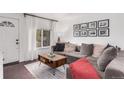 Bright living room featuring a comfortable gray couch, wooden floors, and modern decor at 3929 Shoshone St, Denver, CO 80211