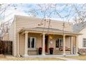 Inviting single-story home featuring a covered porch with classic columns and a porch swing at 3929 Shoshone St, Denver, CO 80211