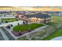 A well-manicured lawn and three-car garage accent this stunning home's exterior at 29303 E 165Th Ave, Brighton, CO 80603