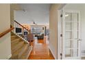 Inviting living room featuring gleaming hardwood floors and a cozy fireplace at 6461 S Ider St, Aurora, CO 80016