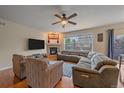 Comfortable living room showcasing a cozy fireplace and natural light at 6461 S Ider St, Aurora, CO 80016