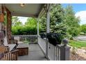 Inviting front porch features ample seating and flower boxes at 14675 Golden Eagle Run, Broomfield, CO 80023