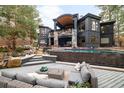 Luxury backyard showcasing a pool, stone waterfall feature, and a spacious deck perfect for entertaining and lounging at 1070 Cypress Way, Castle Rock, CO 80108