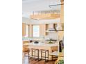 Bright kitchen with light wood cabinetry, marble countertops, an island and modern appliances at 1070 Cypress Way, Castle Rock, CO 80108
