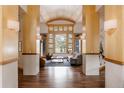 Bright living room featuring wood floors, a vaulted ceiling, and a large window with scenic views at 1070 Cypress Way, Castle Rock, CO 80108