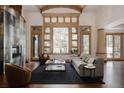 Open-concept living room with hardwood floors, a vaulted ceiling, and a view of the outdoor landscape at 1070 Cypress Way, Castle Rock, CO 80108