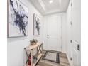 Bright entryway with hardwood floors, modern decor, and a white door at 2598 Knobbie Cir, Castle Rock, CO 80109