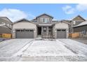 Beautiful two-story home featuring a three-car garage and gray stone accents at 2598 Knobbie Cir, Castle Rock, CO 80109