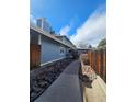 View of the home's walkway and exterior, with stone landscaping and privacy fencing at 264 S Newark Cir, Aurora, CO 80012