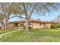 Ranch home with a red roof, large front yard, and mature shade trees at 3906 Hoyt Ct, Wheat Ridge, CO 80033