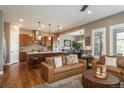 Spacious living room with a cozy seating arrangement, hardwood floors, and lots of natural light at 10660 Winding Pine Pt, Highlands Ranch, CO 80126