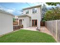 A private backyard retreat features green grass, wood fence, and access to the home at 1385 Birch St, Denver, CO 80220