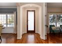 Inviting foyer with hardwood floors and a stylish frosted-glass front door at 1385 Birch St, Denver, CO 80220