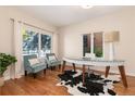 Bright and airy office with hardwood floors, stylish desk, and natural light from two windows at 1385 Birch St, Denver, CO 80220