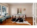 Bright and airy office with hardwood floors, stylish desk, and natural light from two windows at 1385 Birch St, Denver, CO 80220