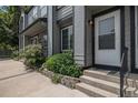 Charming townhome entrance with well-kept greenery, and a welcoming front door at 1919 Newland Ct, Lakewood, CO 80214