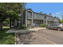 Attractive townhome featuring a gray exterior, front parking, and well-maintained landscaping at 1919 Newland Ct, Lakewood, CO 80214