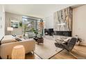 Bright living room with a marble fireplace, hardwood floors, a large window, and stylish furniture at 1717 Irving St, Denver, CO 80204