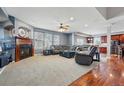 Open-concept living room featuring a cozy fireplace and seamless flow to the kitchen area at 13686 Dexter St, Thornton, CO 80602