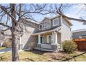 Charming home featuring a cozy front porch with stone accents and a manicured lawn at 5174 W 123Rd Pl, Broomfield, CO 80020
