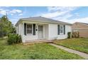 Charming home featuring white exterior and well-maintained lawn at 3715 N Jackson St, Denver, CO 80205