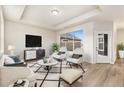 Bright living room with modern decor, plush seating, and a large window for natural light at 308 Josef Cir, Fort Lupton, CO 80621