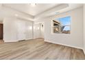 Inviting living space with hardwood floors, ample lighting, and large windows offering scenic views at 308 Josef Cir, Fort Lupton, CO 80621