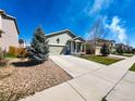 Well kept home with a large driveway, adjacent to green grass and rock features at 541 Park Blvd, Brighton, CO 80603