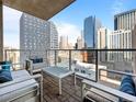 Private balcony with outdoor seating and stunning views of the downtown skyline at 891 14Th St # 1109, Denver, CO 80202