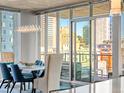 Bright dining room with floor-to-ceiling windows showcasing city views and modern chandelier at 891 14Th St # 1109, Denver, CO 80202