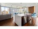 Modern kitchen with white island and stainless steel appliances, with views of the city at 891 14Th St # 1109, Denver, CO 80202