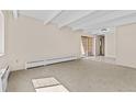 Spacious living room with carpet and sliding door to patio at 800 W Belleview Ave # 201, Englewood, CO 80110