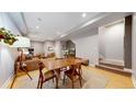Open-concept dining area with wood floors, a modern table set, and seamless access to the living space at 1960 S Sherman St, Denver, CO 80210
