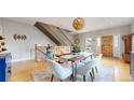 Dining room showcases an open staircase and a wood table with modern white chairs at 1960 S Sherman St, Denver, CO 80210