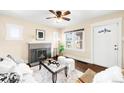 Comfortable living room with fireplace, hardwood floors, and natural light, door leading to front at 3123 N Elizabeth St, Denver, CO 80205