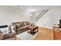 Comfortable living room with plush seating, hardwood floors, and staircase access at 7933 Chase Cir # 182, Arvada, CO 80003