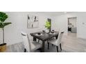 Staged dining room with a neutral color palette, light walls and stylish decor at 1580 S Krameria St, Denver, CO 80224