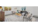 Cozy living room with modern decor, layered tables, soft textures, and bright window view at 1580 S Krameria St, Denver, CO 80224