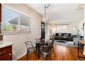 Bright dining area with a view to the living room, featuring hardwood floors and modern furnishings at 2415 Pontiac St, Denver, CO 80207