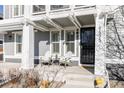 Cozy front porch with seating, offering a welcoming entrance to the home at 9575 E 3Rd Pl, Denver, CO 80230